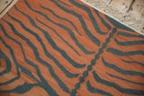 Hand woven vintage Tiger Kilim rug detail, pale rust and dusty teal stripes, fringe.