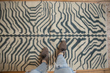 Vintage Kilim rug's bold ivory and charcoal zebra stripe pattern, underfoot.