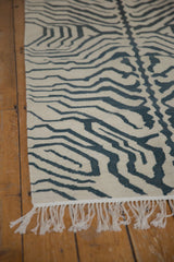 Cream fringe and hand-woven charcoal zebra stripes on this vintage kilim rug.