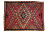 Vintage Indian hand woven Soumac rug, geometric diamond medallions in brick red and earthy tones.