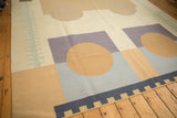 Contemporary Kilim: abstract sand circle, blue geometric blocks, dark blue zipper border.