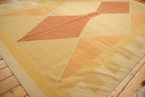 Kilim rug's modern argyle diamond pattern in pale copper, gold, sand, and ivory.