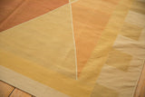 Geometric diamond pattern in gold, sand, and dusty terracotta on vintage kilim.