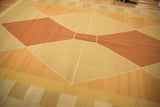 Vintage kilim carpet's modern geometric argyle-inspired pattern with alternating pale copper and gold.