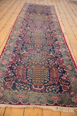 Kerman runner's cochineal fringe, sky blue fleur-de-lis border, and millefleur field detail.