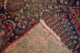 Vintage Kerman runner's intricate millefleur pile and hand-knotted foundation.