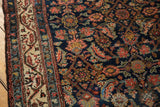 Traditional vintage Hamadan rug close-up: navy Herati motif and ivory boteh border.