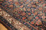 Navy field with dense Herati motif and ivory Mir Serbend boteh border of a vintage Hamadan rug.