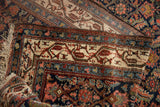 Ivory Mir Serbend boteh border and navy Herati patterned field of a vintage Hamadan rug.