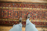 Intricate floral medallions on the camel field of a late 19th-century Persian Serab runner.