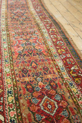 Long view of an antique Serab runner's repeating floral medallions and rich, naturally-dyed palette.