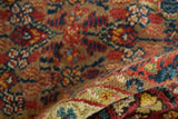 Folded view of an antique Serab runner showing its dense pile and varied surface texture.