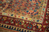 Reciprocating pawn design and floral borders in madder red and sapphire blue on an antique Serab rug.