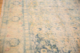 Close view of the vintage carpet's even wear, showing distressed Herati motifs in blue and ivory.