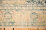 Textured, even wear on a distressed vintage rug's border, with sky blue and cinnabar red Herati motifs.