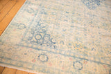 Distressed texture and faded sky blue motifs on the corner of a vintage Bulgarian Herati carpet.