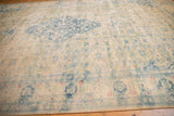 Angled view highlighting the even wear and faded blue Herati design of a distressed Bulgarian carpet.