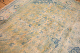 Patches of gold and blue on the distressed, low-pile surface worn to knot heads.
