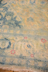 Evenly worn pile of a distressed vintage carpet showing faded gold, blue, and cinnabar red Herati details.