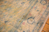 Even wear and distressed texture on a vintage Herati rug with faded sky blue and gold motifs.