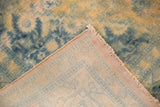 Corner view of the hand-knotted foundation and secured fringe on the distressed Bulgarian carpet.