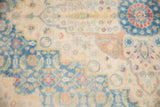 Distressed texture of a vintage Herati carpet with sky blue and pale terra cotta motifs.