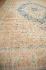 Angled view of the worn Herati pattern across the pale copper border and scalloped ivory field.