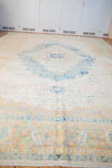 Low angle view of the distressed vintage Herati rug, emphasizing its grand scale and soft color palette.