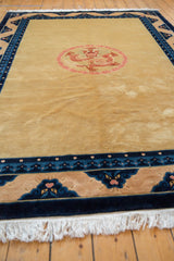 White fringe and dark blue dragon border with pearl motif on a vintage Peking carpet.