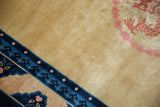High-pile gold field with intricate blush dragon and blue pawn border on a vintage Chinese Peking carpet.
