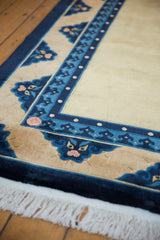 Corner of vintage Peking carpet: cobalt, sky blue borders, pearl, pawn motifs, blush.
