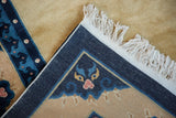 Hand knotted indigo backing, white fringe, and curvilinear cobalt blue border on vintage Peking carpet.