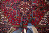 A perspective view of the plush, full pile and sharp serrated medallion on a vintage Mehrivan carpet.