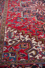 Detailed view of the plush wool pile and geometric turtle border on a vintage Mehrivan carpet.