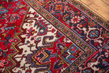 Full wool pile and geometric turtle border detail of a vintage Persian Mehrivan carpet.