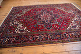 Full pattern view of a vintage Mehrivan carpet with its serrated medallion and meandering turtle design border.