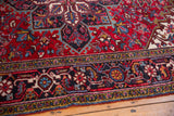 The meandering turtle design main border in navy blue, cherry red, and dusty gold.