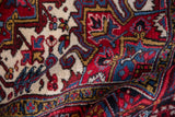 A soft fold revealing the geometric relief and dense wool pile of a vintage Mehrivan carpet.