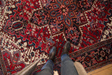 The full, plush pile of a vintage Persian Mehrivan rug with a sharp serrated medallion.