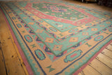 Indian Stone Wash Dhurrie carpet's geometric corner with primitive motifs in green, red, and sand.