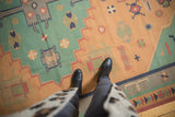 Vintage stone wash Dhurrie flatweave rug with geometric patterns in dusty gold and pale turquoise.