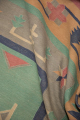 Hand-woven vintage Dhurrie texture with geometric pale turquoise, raspberry, and dusty gold designs.