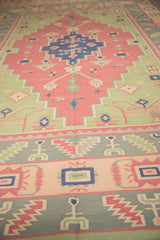 Vintage Indian Dhurrie rug's geometric border with abstract plant motifs in muted hues.