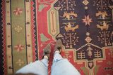 Hand woven geometric Dhurrie rug detail with tree-of-life motifs, animals, navy, raspberry, sage.