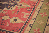 Dusty raspberry brick red and beige geometric animal motif on a vintage Dhurrie carpet.