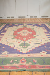 Vintage Indian Dhurrie rug corner showing faded blue stepped spandrel, red and green border.