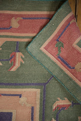 Vintage Dhurrie carpet corner reveals flatweave texture, mallard green, and original selvages.