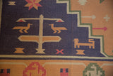 Dusty navy field with gold geometric birds, starburst, and tree-like motifs.