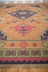 Vintage Dhurrie carpet border with geometric pinwheel design, raspberry band, and fringe.