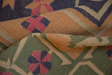 Vintage Dhurrie flatweave detail showcasing gold, dusty navy, and raspberry geometric patterns.